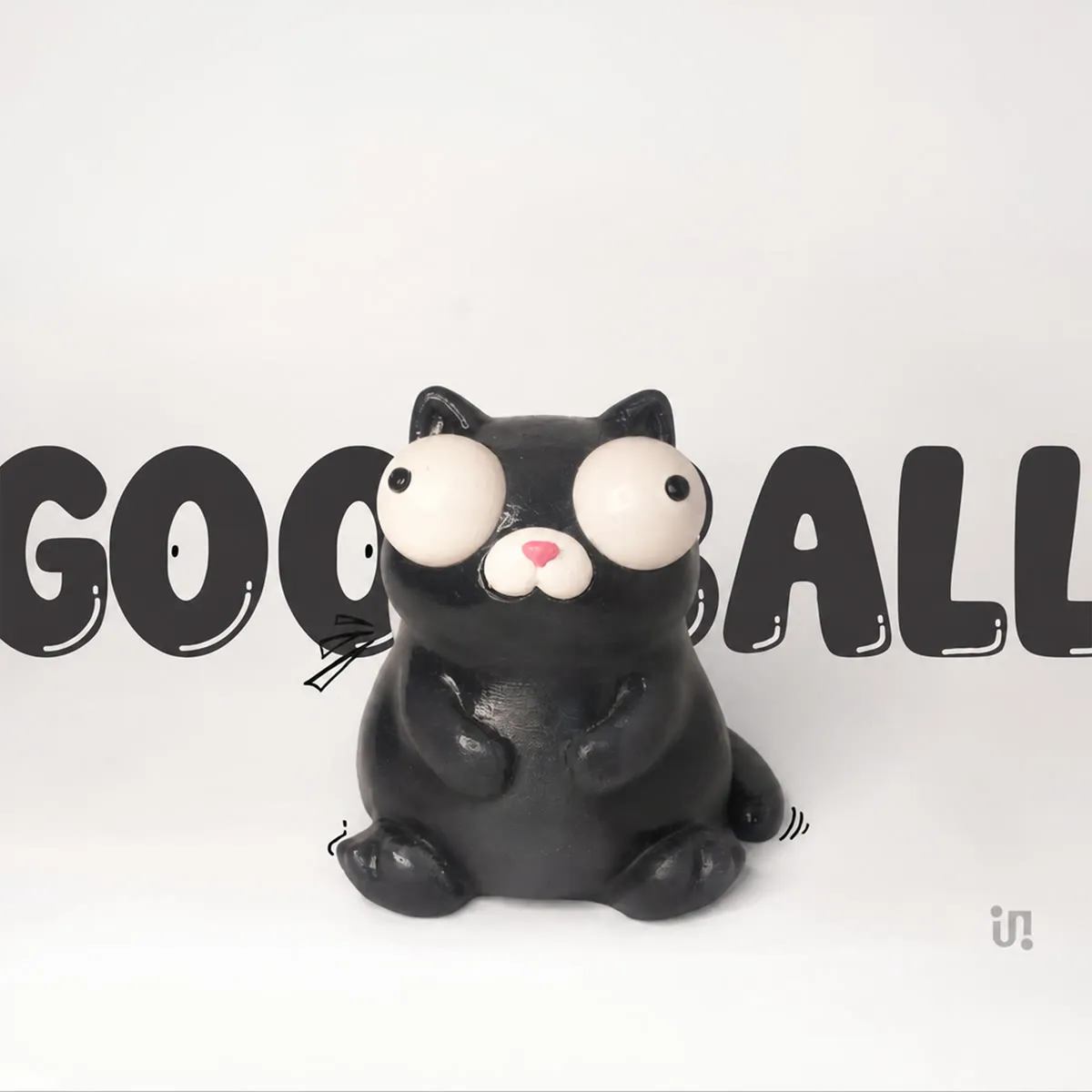 Goofball, a black hand-painted cat figure with oversized googly eyes.
